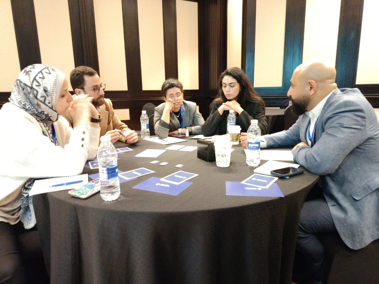 A team discussing their next move around the table